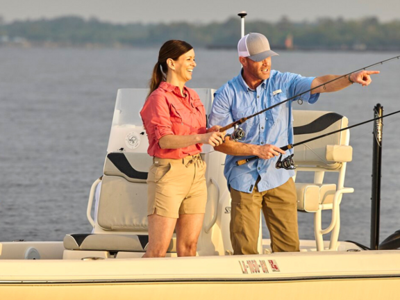 A man and woman fish on a boat in Louisiana.
