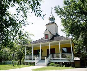 A quaint white-and-yellow church at Vermilionville Living History Museum and Folk Life Park in Lafayette.