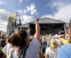 A fan enjoys music at the Fais Do Do Stage at Jazz Fest.
