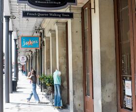 A hanging sign for 1850 House advertises the Louisiana State Museum site as a way for visitors to explore life in 1850s New Orleans.